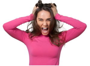 A woman in a pink shirt grabbing her hair in frustration.