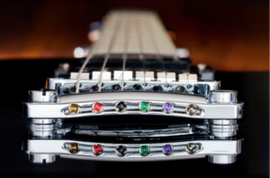 An electric guitar fretboard with guitar strings from the guitar bridge point of view.