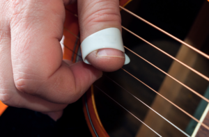 Hybrid picking an acoustic guitar.