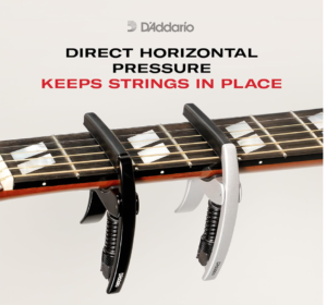 Two capos on a guitar fretboard. Direct Horizontal Pressure Keeps Strings In Place.